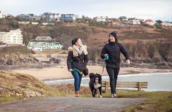 Couple walking their dog in winter clothes