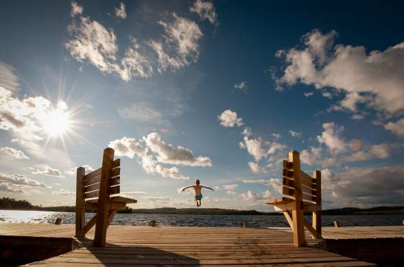boy jumping off the dock