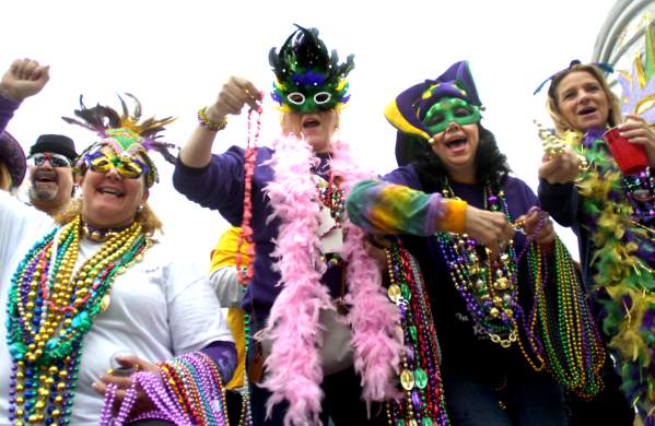 People dressed with masks and beads for Mardi Gras
