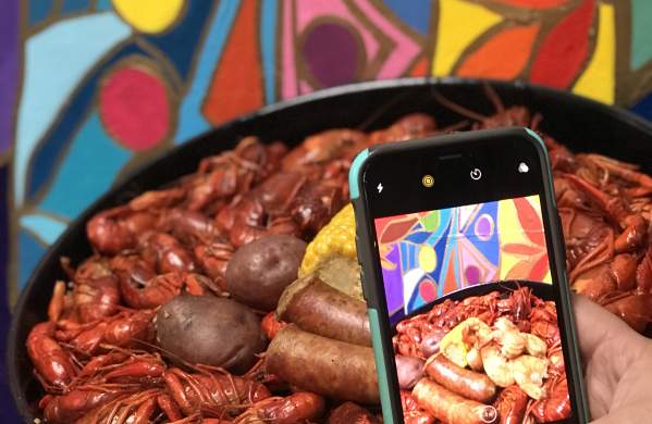 Phone taking a picture of a Beaumont crawfish dish