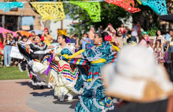 Photo of women in traditional Jalisco Ribbon Dresses dancing at Pat Coursey Park during Cinco De Mayo Celebration in 2025.