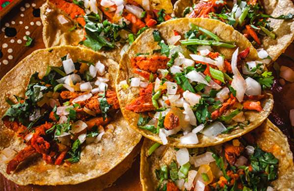Al Pastor tacos with onion and cilantro