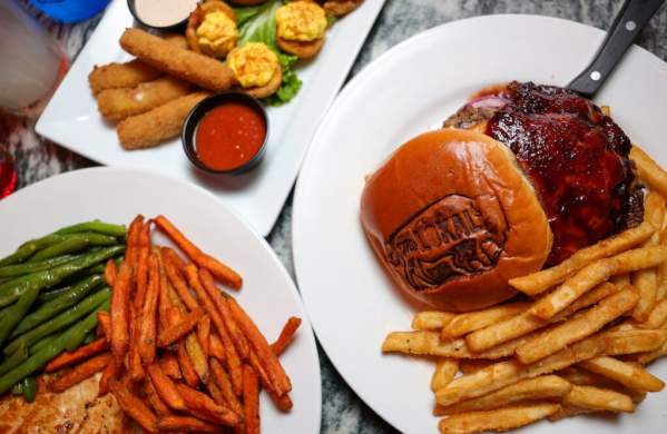 Overhead image of burgers, fries, and other eats from The Lokal in Norman, Oklahoma