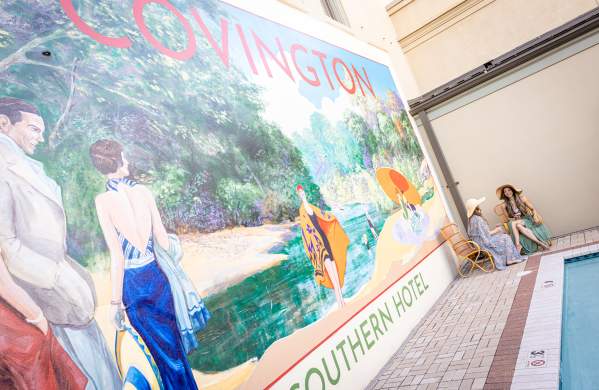 Southern Hotel's poolside Covington mural and guests