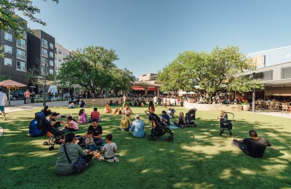 people picnicking on the Northside Lawn at the Domain NORTHSIDE shopping area