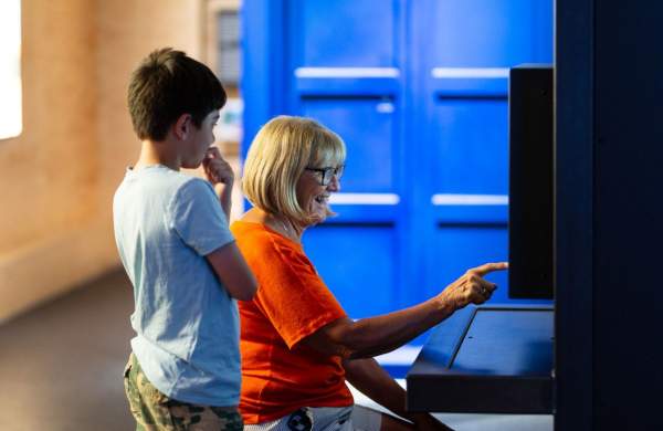 Woman and child pointing at exhibit at We The Curious in Bristol