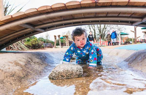 Child under bridge in Slimbridge's Welly Boot Land - credit WWT and Clem Stevens