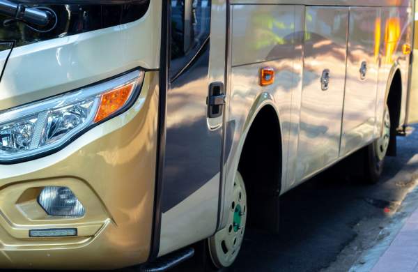 Gold coach parked by the side of the road