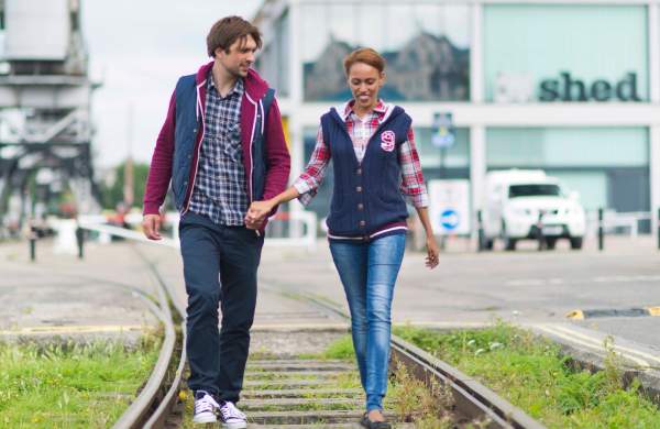 A couple walking on a train track on the southern bank of Bristol's Harbourside - credit Visit Bristol