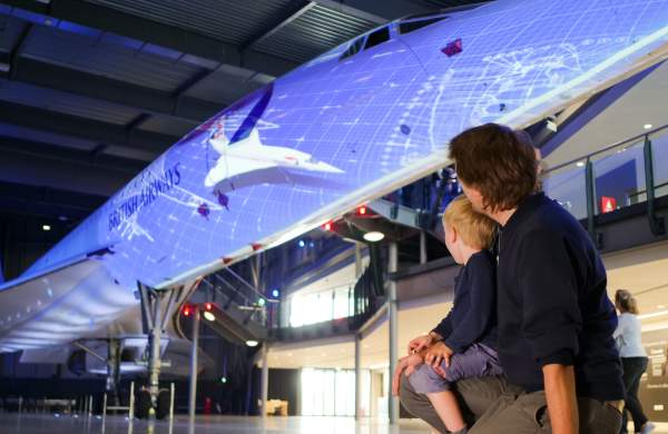 A father and son in front of the Concorde Alpha Foxtrot supersonic airliner at Aerospace Bristol - credit Adam Gasson