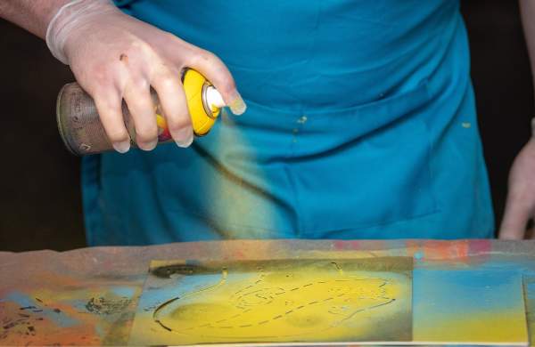 A person spraying a paint can onto a canvas at Graft Bristol - credit Yuup