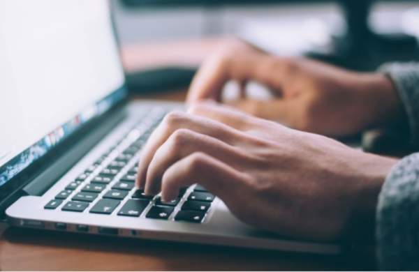 Person typing on laptop