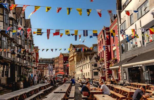 A view of the eastern end of King Street in central Bristol, with the historic Llandoger Trow pub on the left and the modern King Street Brew House on the right