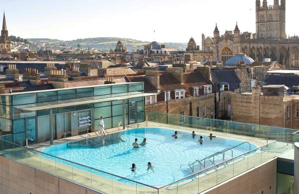 An aerial view of the rooftop pool at the Thermae Bath Spa in central Bath near Bristol, with Bath's skyline in the background