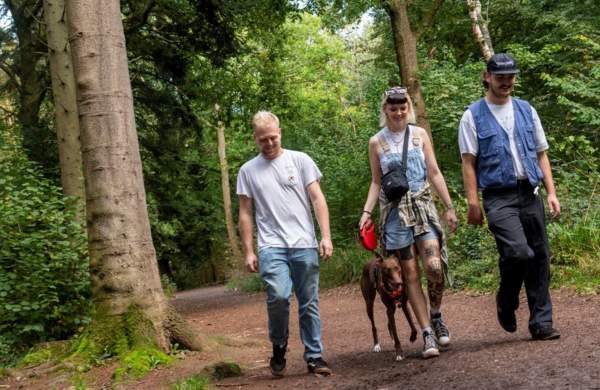 People walking a dog in Leigh Woods in Bristol - credit Forestry England