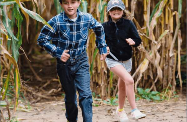 children running thru corn