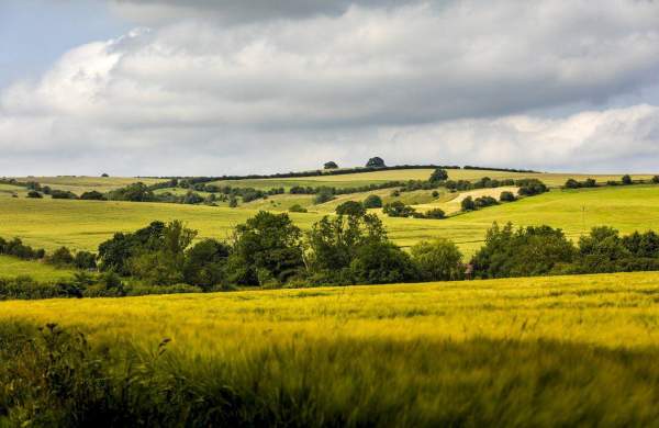 A landscape of hills and farming fields under cloudy skies in Lincolnshire