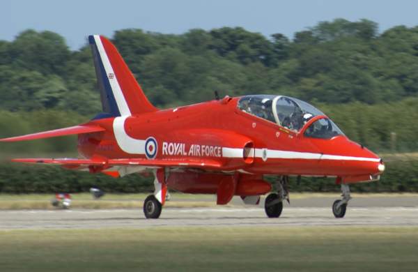 Red arrow plane on the run way getting ready for flight