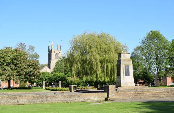 A landscape of Bourne Church and memorial with clear skies