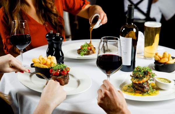 A group of friends enjoying a fine dining steak night