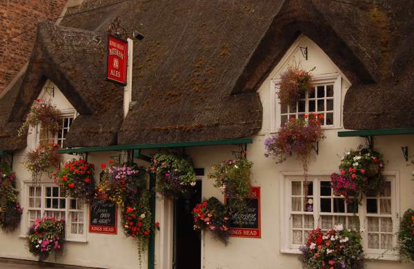 picture of a house in Horncastle covered with flower baskets