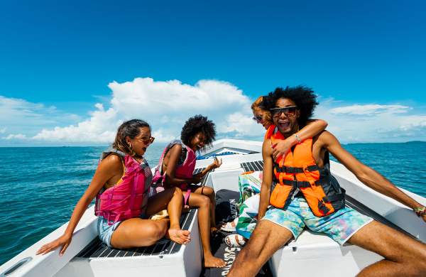Friends enjoying a beautiful sunny day on a boat on the beaches of the Gulf of Chiriqui