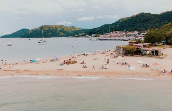 People enjoying the beach, view of the town of Taboga in the background, Taboga Island Panama Province, Panamá