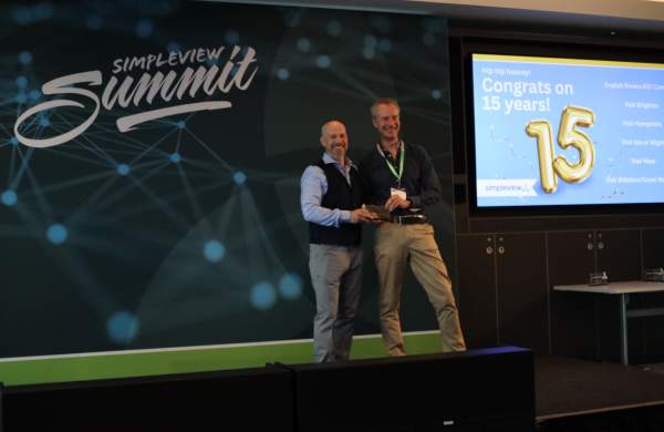 Visit Hampshire's Andrew Bateman Accepts 15 Year Client Award from Simpleview MD Richard Veal