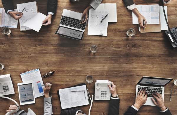 Overhead view of multiple people working at table