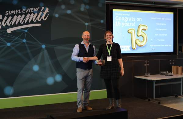 Visit Brighton's Charlotte Barrow Accepts 15 Year Client Award from Simpleview MD Richard Veal