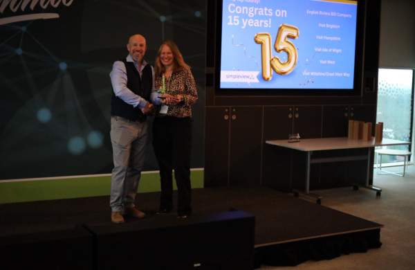 Visit Wiltshire/Great West Way's Fiona Errington Accepts 15 Year Client Award from Simpleview MD Richard Veal
