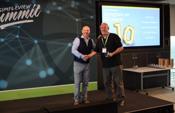 Visit Scotland's Jon Flannagan Receives Ten Year Client Award from Simpleview MD Richard Veal