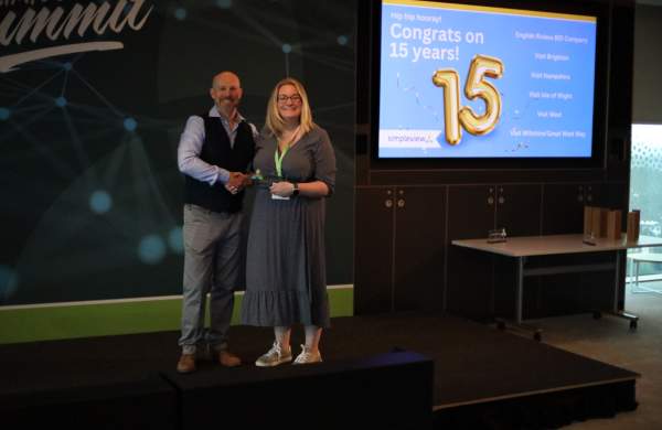 Visit West's Laura Valentine Accepts 15 Year Client Award from Simpleview MD Richard Veal