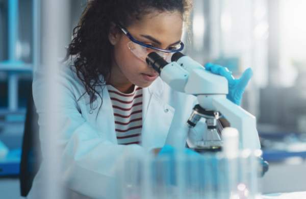 Person Using Microscope