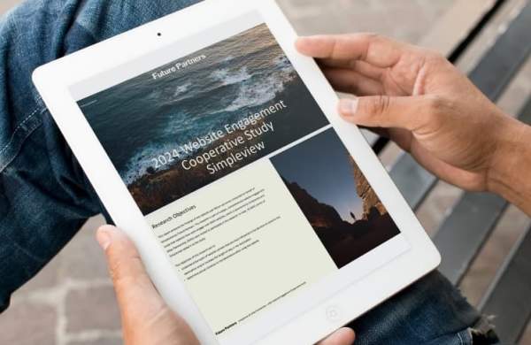 A person sitting on a park bench with their tablet open to the front page of the Simpleview website engagement study.