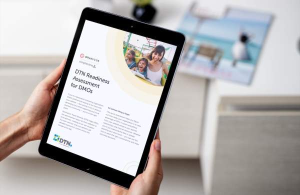 A person holds a tablet open to the DTN Readiness Assessment for DMOs.