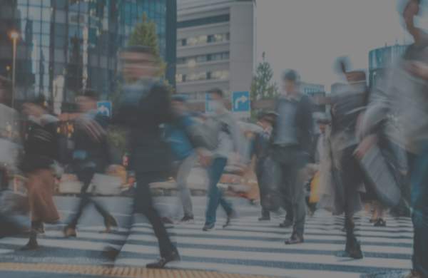 People making their way through a busy crosswalk.