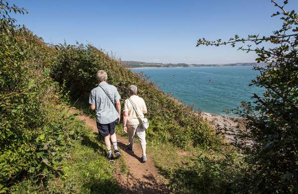 Older couple walking on the coastal path at Oxwich.