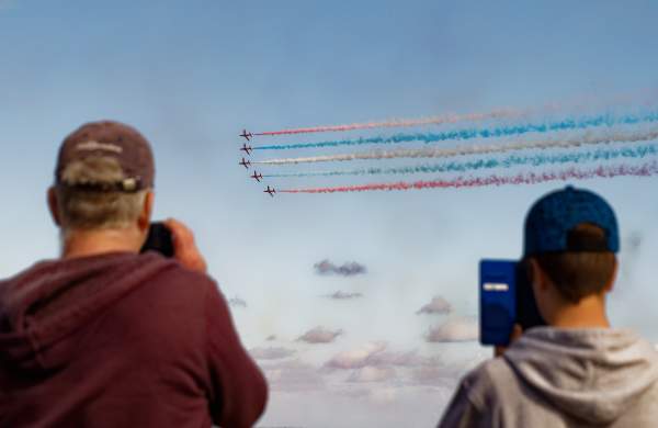 People taking photos of the red arrows at the Wales Airshow