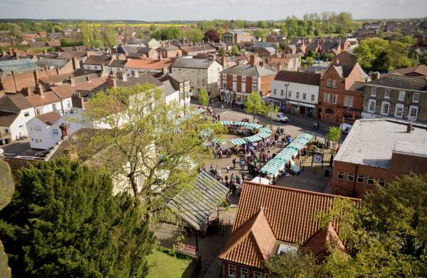 an aerial view of Market Rasen market with stalls and trees in foreground