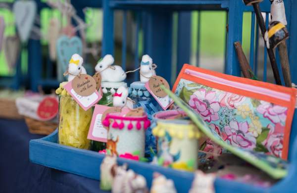 a close up of handmade produce on a counter including pencil case and small rabbits