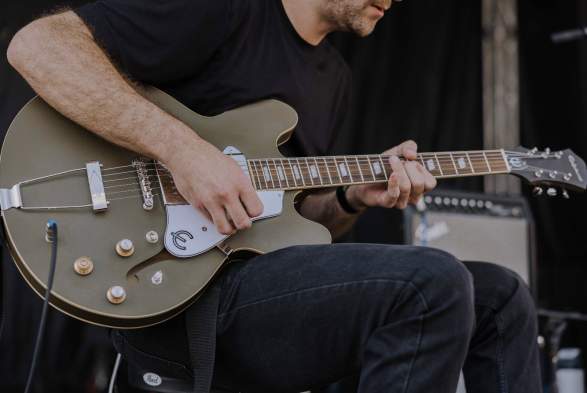 Close-up of a musician playing an electric guitar during a live performance