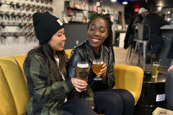 Two friends grabbing drinks at District 1 Brewing.