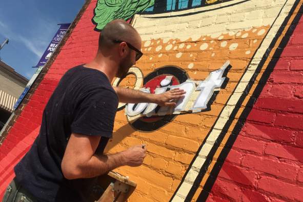 Artist Nick Goettling paints the #GrabTheGlass mural in downtown Stevens Point, celebrating the Point Brewery's 160 year anniversary!