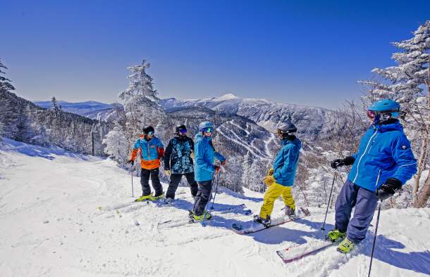Skiers at Summglers Notch shredding slopes