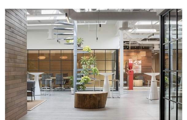 Indoor meeting venue at Hula Lakeside, featuring high ceilings, earthy decor, and an open concept seating area.