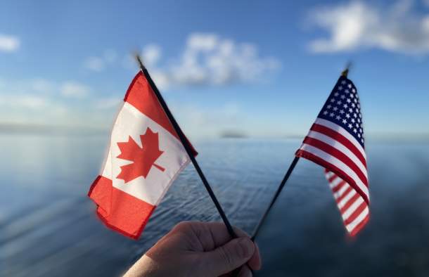 Canadian and United States Flags against Lake Champlain background