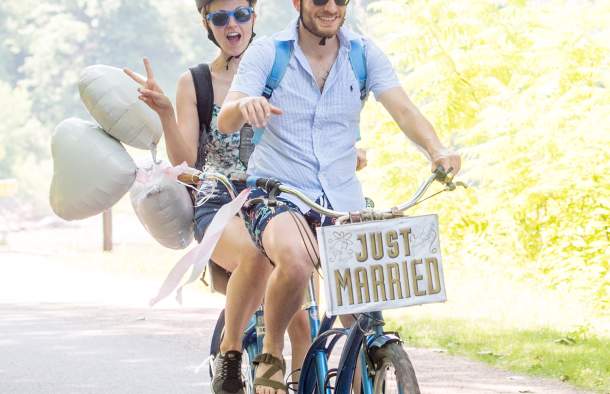 new bride and groom on tandem bike just married