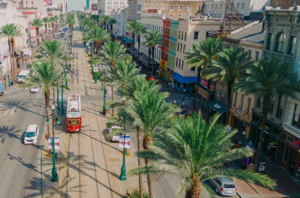 Streetcars Roll Along Canal Street - Downtown New Orleans