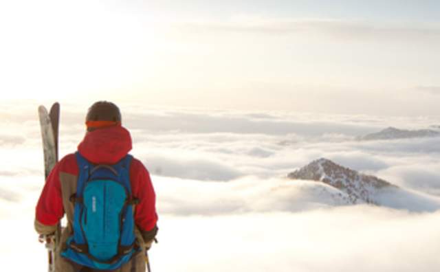 Skiier at the top of the Mountain